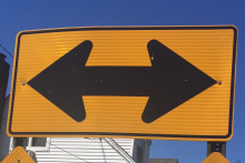 picture of a highway sign depicting two directions traffic can travel
