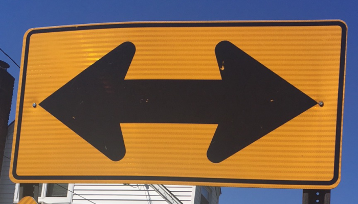 picture of a highway sign depicting two directions traffic can travel